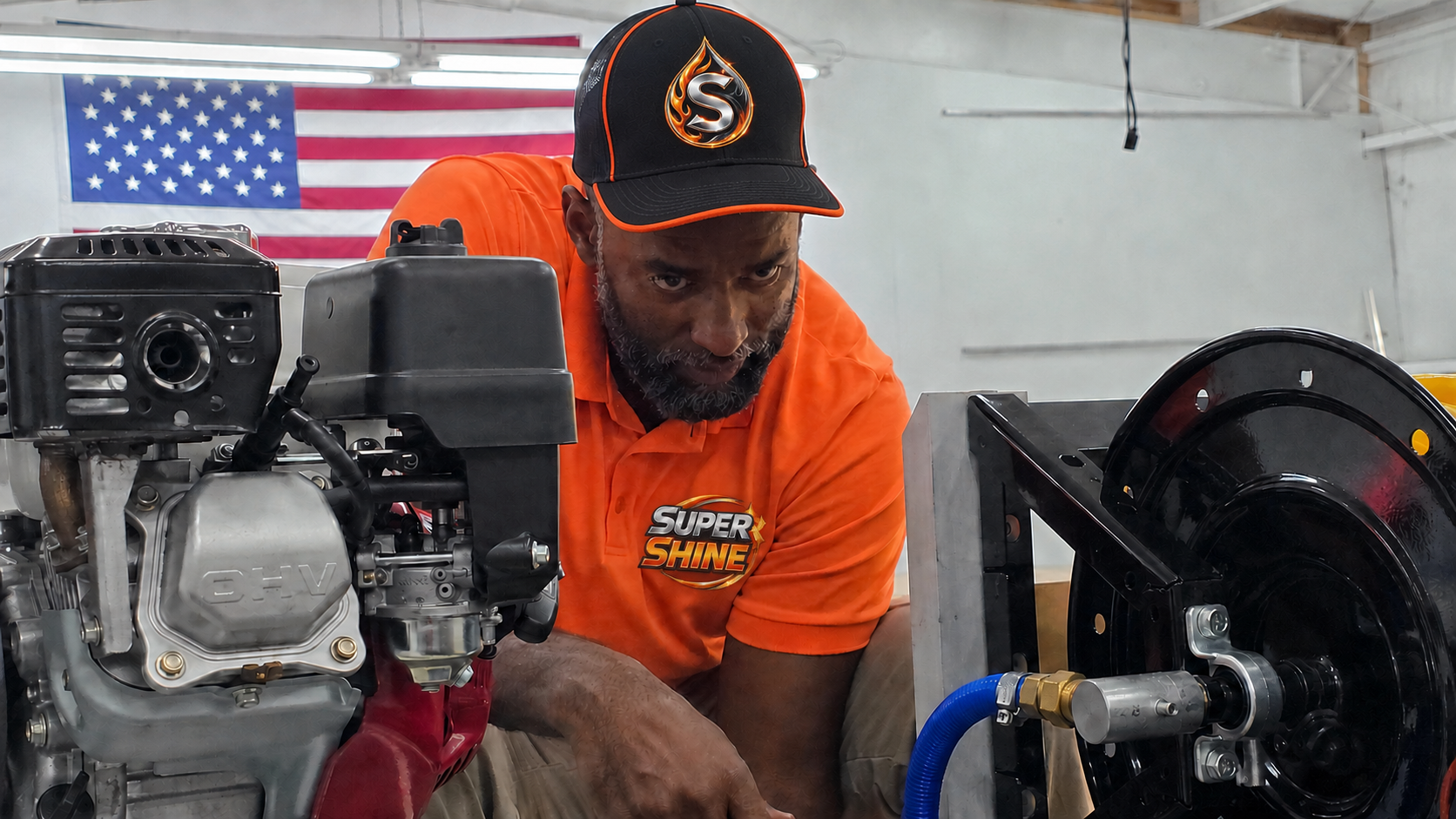 Nick Thomas working on SuperShine equipment in a bright orange shirt and branded hat